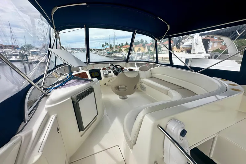 Slide: The Image of 2005 Meridian 459 Motoryacht interior with helm, seating, and marina view. - 13