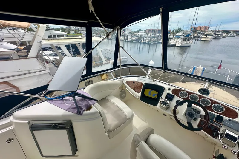 Slide: The Image of 2005 Meridian 459 Motoryacht helm with navigation equipment, docked at marina. - 15