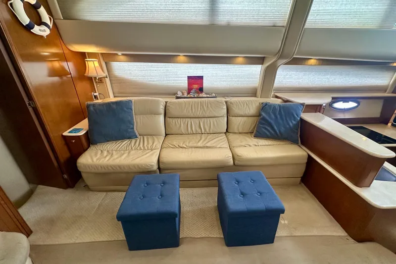 Slide: The Image of Luxurious interior of 2005 Meridian 459 Motoryacht with beige sofa and blue ottomans. - 19
