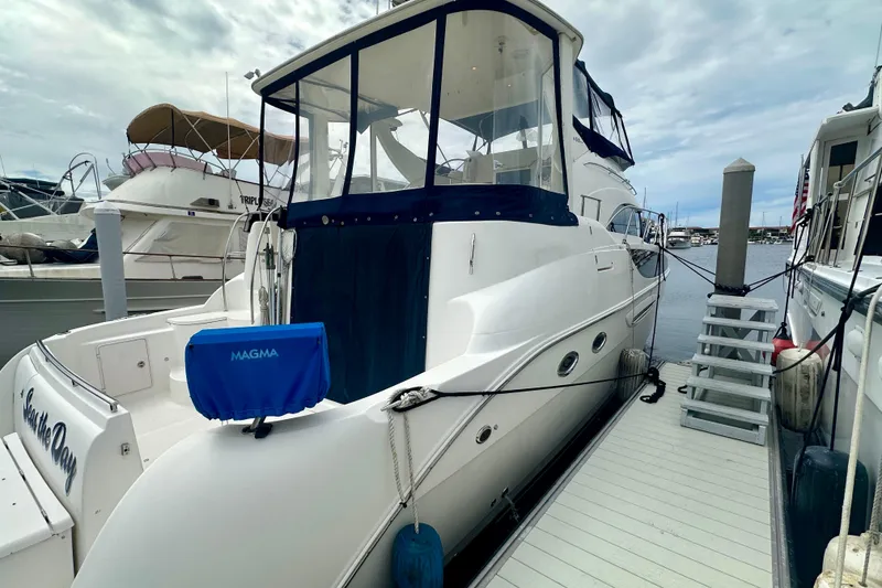 Slide: The Image of 2005 Meridian 459 Motoryacht docked at marina, featuring sleek design and spacious deck. - 2