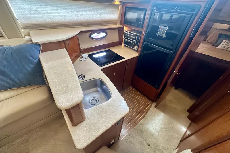 Slide: The Image of 2005 Meridian 459 Motoryacht kitchen with sink, stove, and refrigerator. - 22