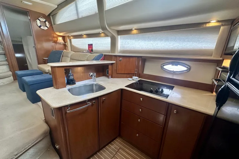 Slide: The Image of Luxurious interior of 2005 Meridian 459 Motoryacht with modern kitchen and seating area. - 25