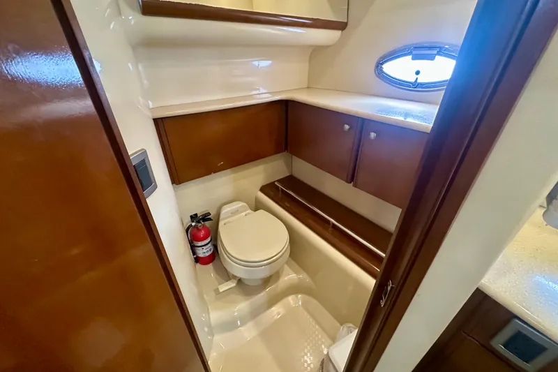 Slide: The Image of Bathroom interior of 2005 Meridian 459 Motoryacht with wooden cabinets and porthole window. - 29