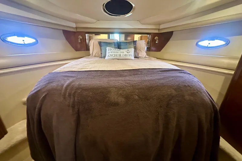 Slide: The Image of Luxurious bedroom interior of 2005 Meridian 459 Motoryacht with cozy bedding and porthole windows. - 32