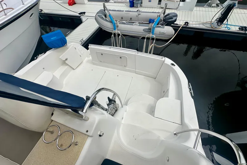 Slide: The Image of 2005 Meridian 459 Motoryacht docked, featuring spacious deck and tender boat. - 8