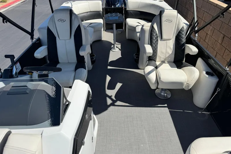 Slide: The Image of 2021 Manitou 25 LX SHP boat interior with luxurious seating and modern design. - 12