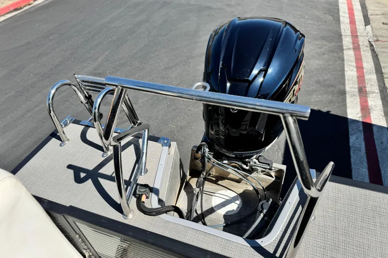 Slide: The Image of 2021 Manitou 25 LX SHP boat with outboard motor and stainless steel ladder. - 19