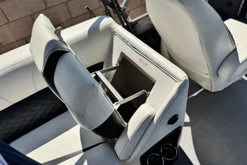 Slide: The Image of 2021 Manitou 25 LX SHP boat seat with storage compartment open. - 21