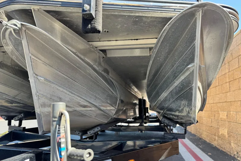 Slide: The Image of 2021 Manitou 25 LX SHP pontoon boat on trailer, close-up of aluminum hull. - 4