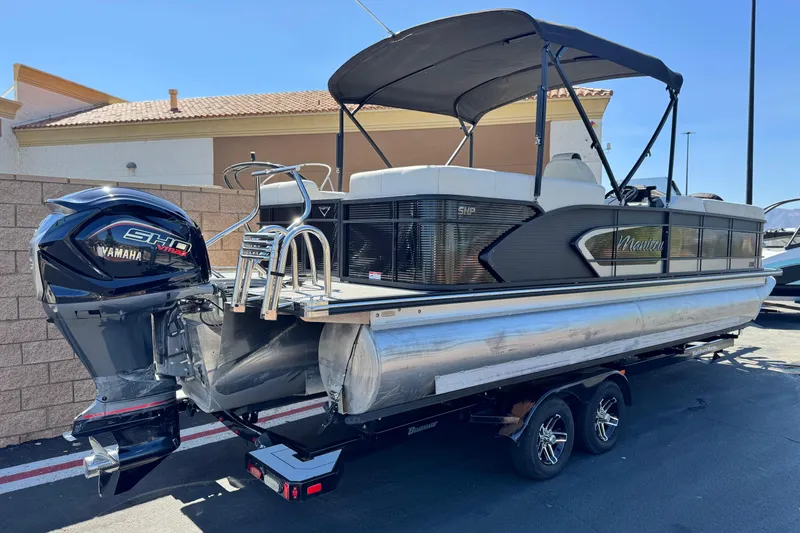Slide: The Image of 2021 Manitou 25 LX SHP pontoon boat with Yamaha engine on a trailer. - 6