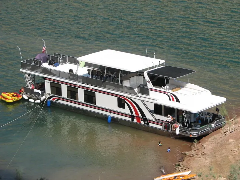 Slide: The Image of Sumerset Solar Express 2007 houseboat docked at shore. - 2
