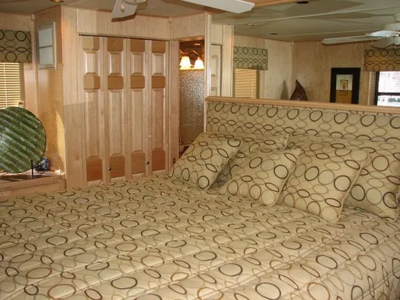 Slide: The Image of Interior of a 2007 Sumerset Solar Express with patterned bedding. - 9