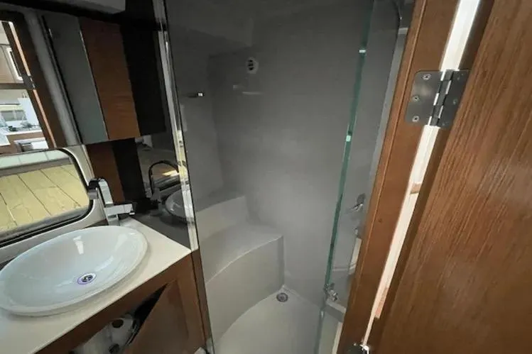 Slide: The Image of 2018 Cruisers Yachts 390 Express Coupe bathroom with modern fixtures and glass shower. - 10