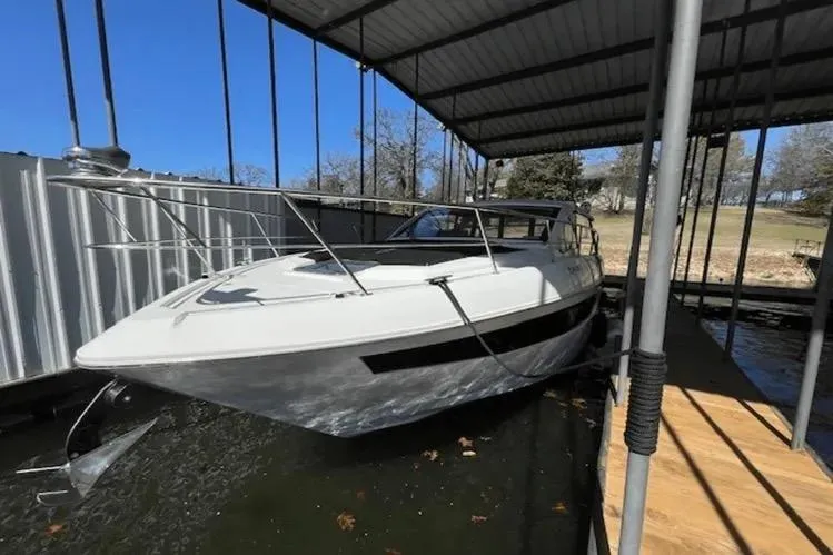 Slide: The Image of 2018 Cruisers Yachts 390 Express Coupe docked under a covered marina. - 3