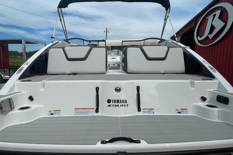 Slide: The Image of 2024 Yamaha Boats SX250, rear view showcasing spacious deck and seating area. - 3