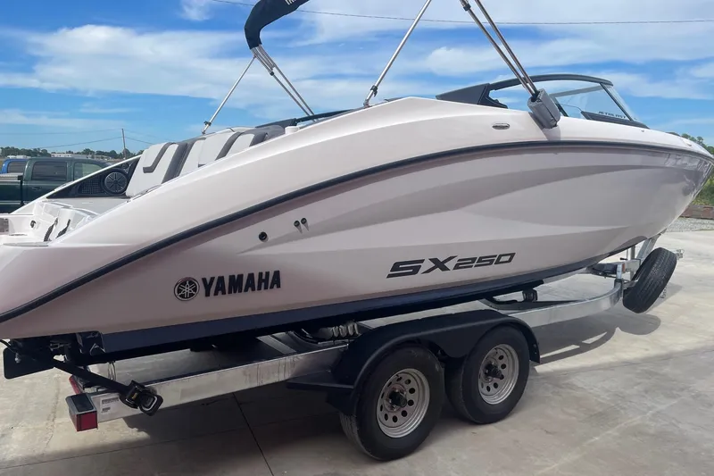 Slide: The Image of 2024 Yamaha Boats SX250 on trailer, sleek design under clear blue sky. - 4