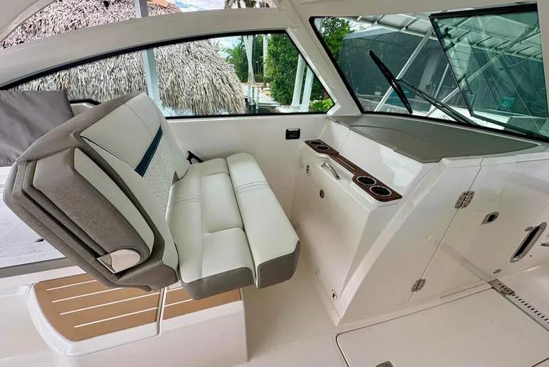 Slide: The Image of 2024 Tiara Yachts 34 LX interior with luxurious seating and modern dashboard. - 13