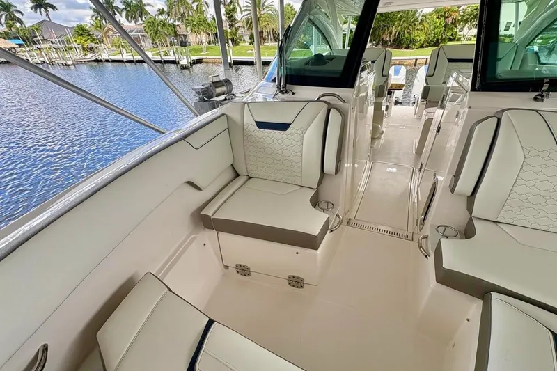 Slide: The Image of 2024 Tiara Yachts 34 LX interior with luxurious seating and waterfront view. - 20