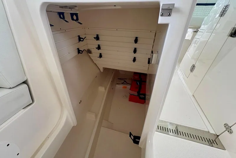 Slide: The Image of 2024 Tiara Yachts 34 LX interior storage compartment with organized shelving. - 21
