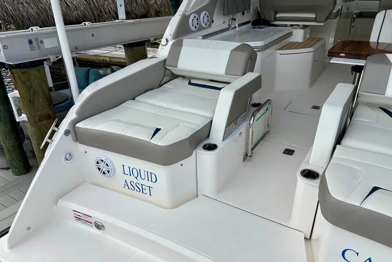 Slide: The Image of 2024 Tiara Yachts 34 LX interior with "Liquid Asset" text, featuring luxurious seating. - 6