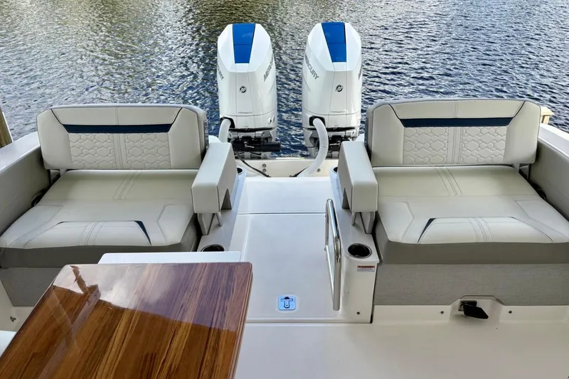 Slide: The Image of 2024 Tiara Yachts 34 LX with luxurious seating and dual Mercury outboard engines. - 9