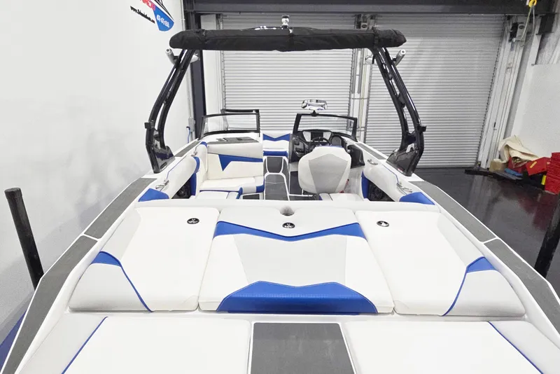 Slide: The Image of 2026 Supreme S220 boat interior with white and blue seating, sleek design. - 5