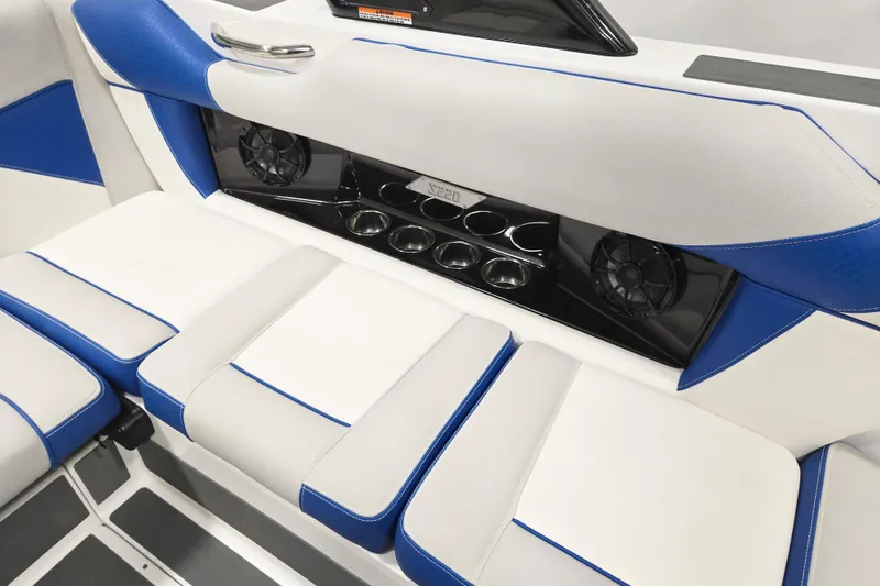 Slide: The Image of 2026 Supreme S220 boat interior with blue and white seating, cup holders, and speakers. - 8