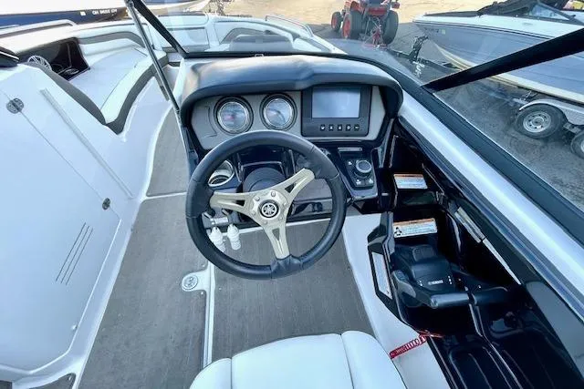 Slide: The Image of 2015 Yamaha Boats 242 Limited S cockpit with steering wheel and dashboard controls. - 10