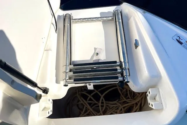 Slide: The Image of 2015 Yamaha Boats 242 Limited S swim platform with ladder and storage compartment. - 17