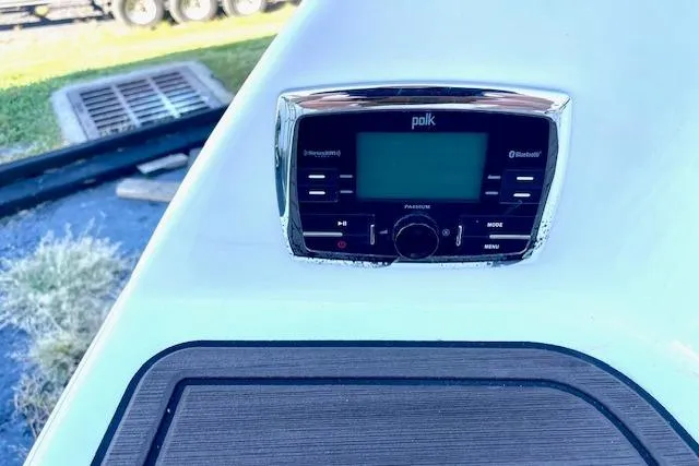Slide: The Image of Polk audio system on 2015 Yamaha Boats 242 Limited S dashboard, featuring Bluetooth connectivity. - 23