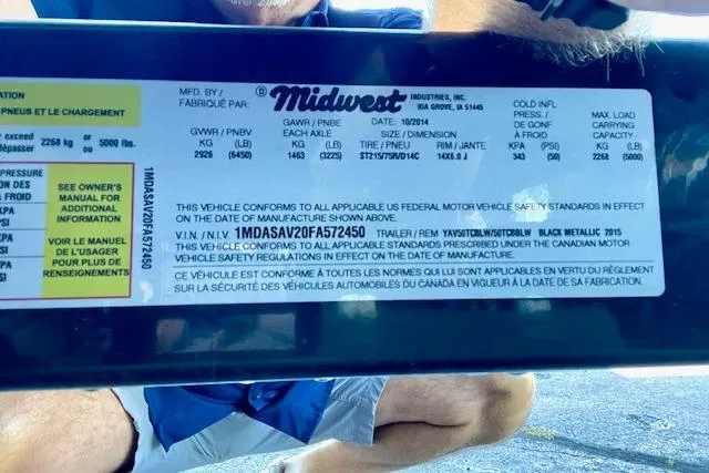 Slide: The Image of Label on a 2015 Yamaha Boats 242 Limited S trailer, detailing safety standards and specifications. - 24