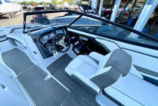 Slide: The Image of Interior view of 2015 Yamaha Boats 242 Limited S, featuring sleek dashboard and seating. - 9
