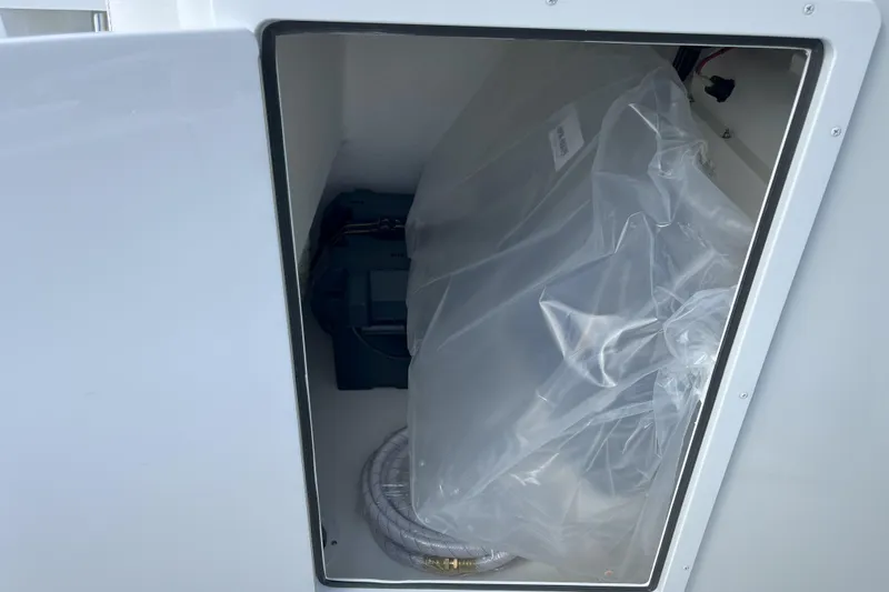 Slide: The Image of Storage compartment of 2026 Parker 180 Coastal boat with equipment and wiring. - 10