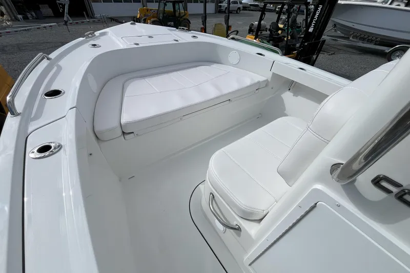 Slide: The Image of 2026 Parker 180 Coastal boat interior with white seating and stainless steel accents. - 5