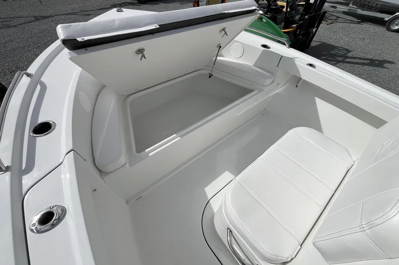 Slide: The Image of 2026 Parker 180 Coastal boat interior with open storage compartment and white seating. - 6
