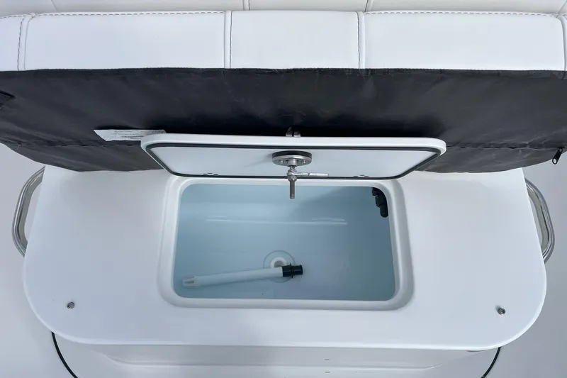 Slide: The Image of 2026 Parker 180 Coastal boat with white seating and clear windshield, outdoors under blue sky. - 7