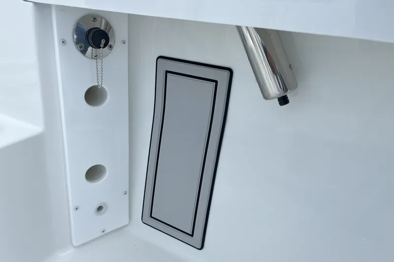 Slide: The Image of 2026 Parker 180 Coastal boat detail showing fuel cap and rod holder. - 9