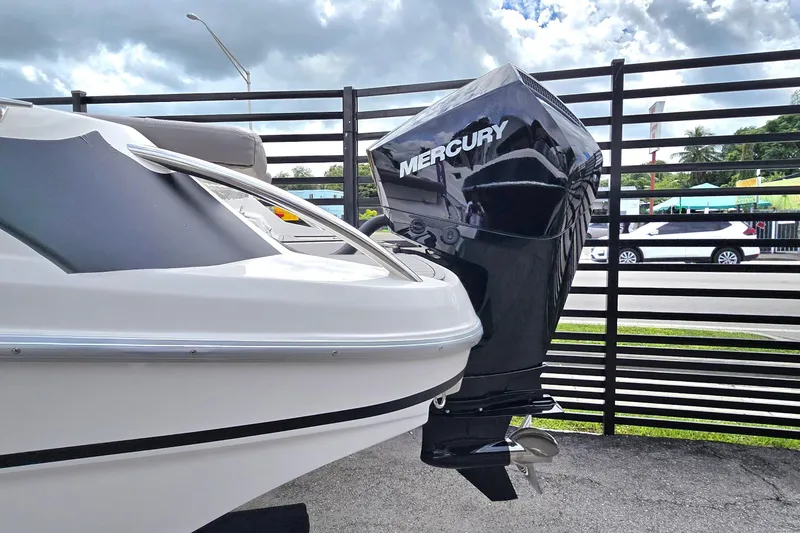 Slide: The Image of 2025 Ventura boat with Mercury outboard motor, parked outdoors under cloudy sky. - 11