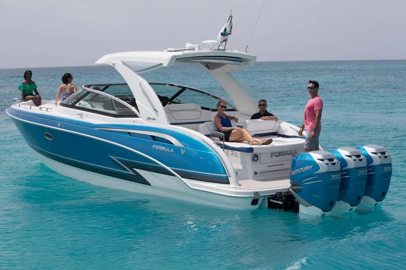 Slide: The Image of 2018 Formula 350 Crossover Bowrider OB on water, showcasing spacious deck and seating. - 10