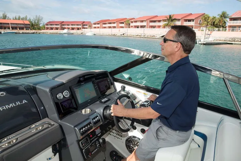 Slide: The Image of 2018 Formula 350 Crossover Bowrider OB with triple Mercury outboard engines on a sunny day. - 15