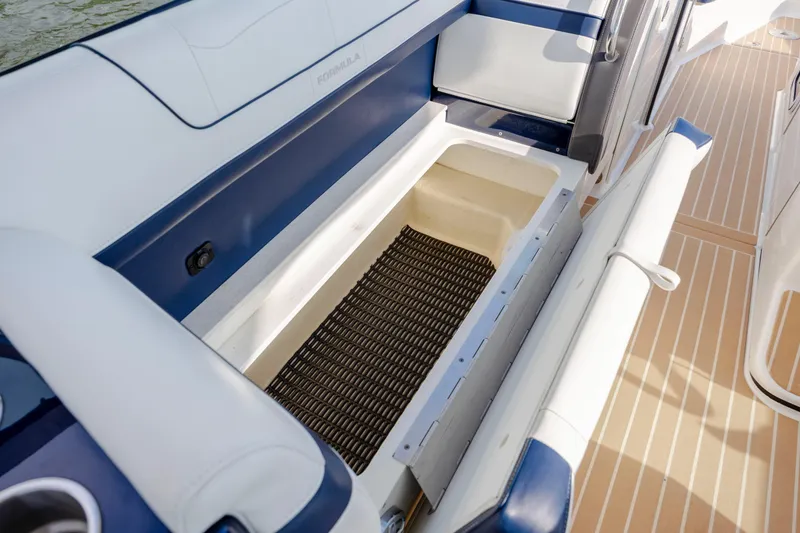 Slide: The Image of 2018 Formula 350 Crossover Bowrider OB with open storage compartment on deck. - 23