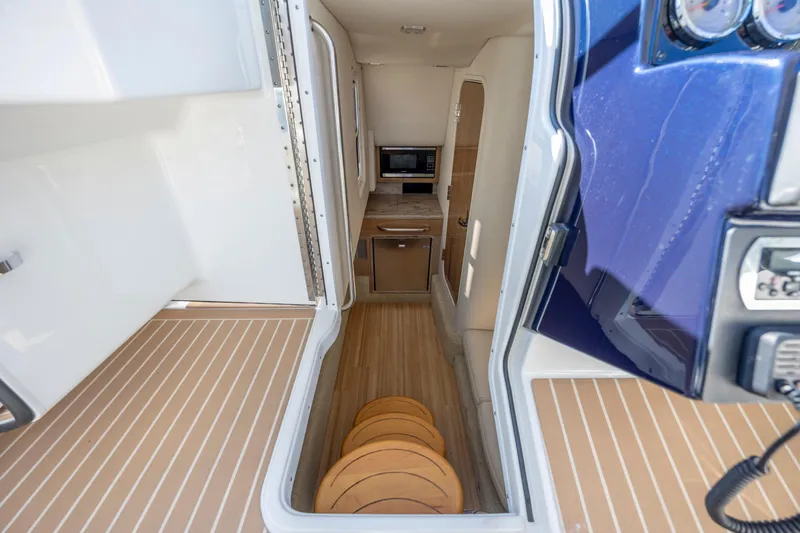 Slide: The Image of 2018 Formula 350 Crossover Bowrider OB interior with kitchenette and seating area. - 33