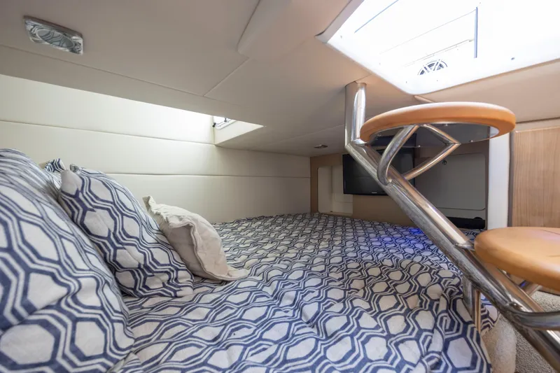 Slide: The Image of 2018 Formula 350 Crossover Bowrider OB cabin with patterned bedding and modern interior design. - 39