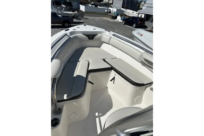Slide: The Image of 2023 Sailfish 220CC boat interior with cushioned seating and table. - 6
