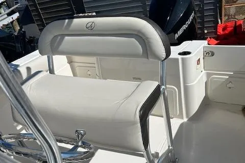 Slide: The Image of 2023 Sailfish 220CC boat interior with white seating and Mercury engine. - 9
