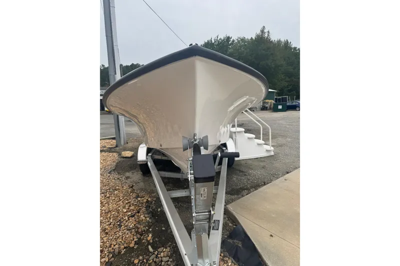 The Image of 2026 C-Hawk 23 Center Console boat on trailer, front view, outdoors. - 1