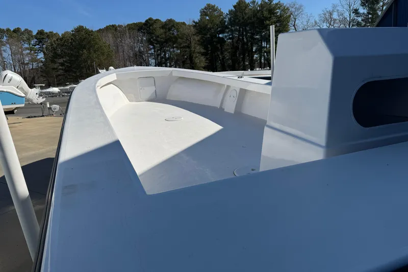 Slide: The Image of 2026 C-Hawk 23 Center Console boat, white deck, outdoor setting, surrounded by trees. - 12