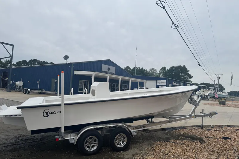 Slide: The Image of 2026 C-Hawk 23 Center Console boat on trailer at marine dealership. - 4