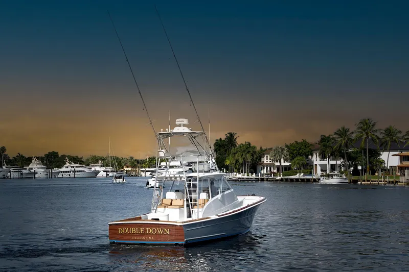 The Image of 2014 Release Walkaround boat "Double Down" on a scenic waterfront with palm trees. - 0