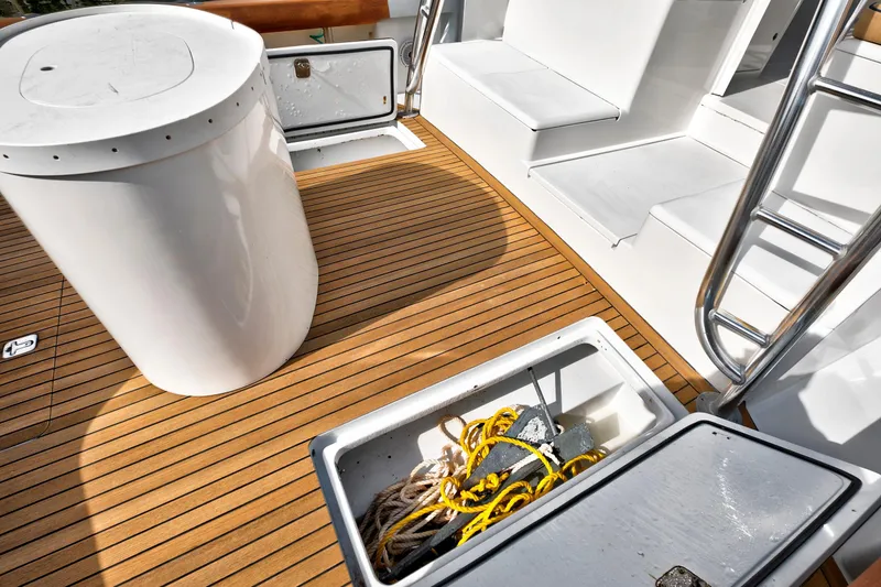 Slide: The Image of 2014 Release Walkaround boat deck with storage compartments and ladder. - 10